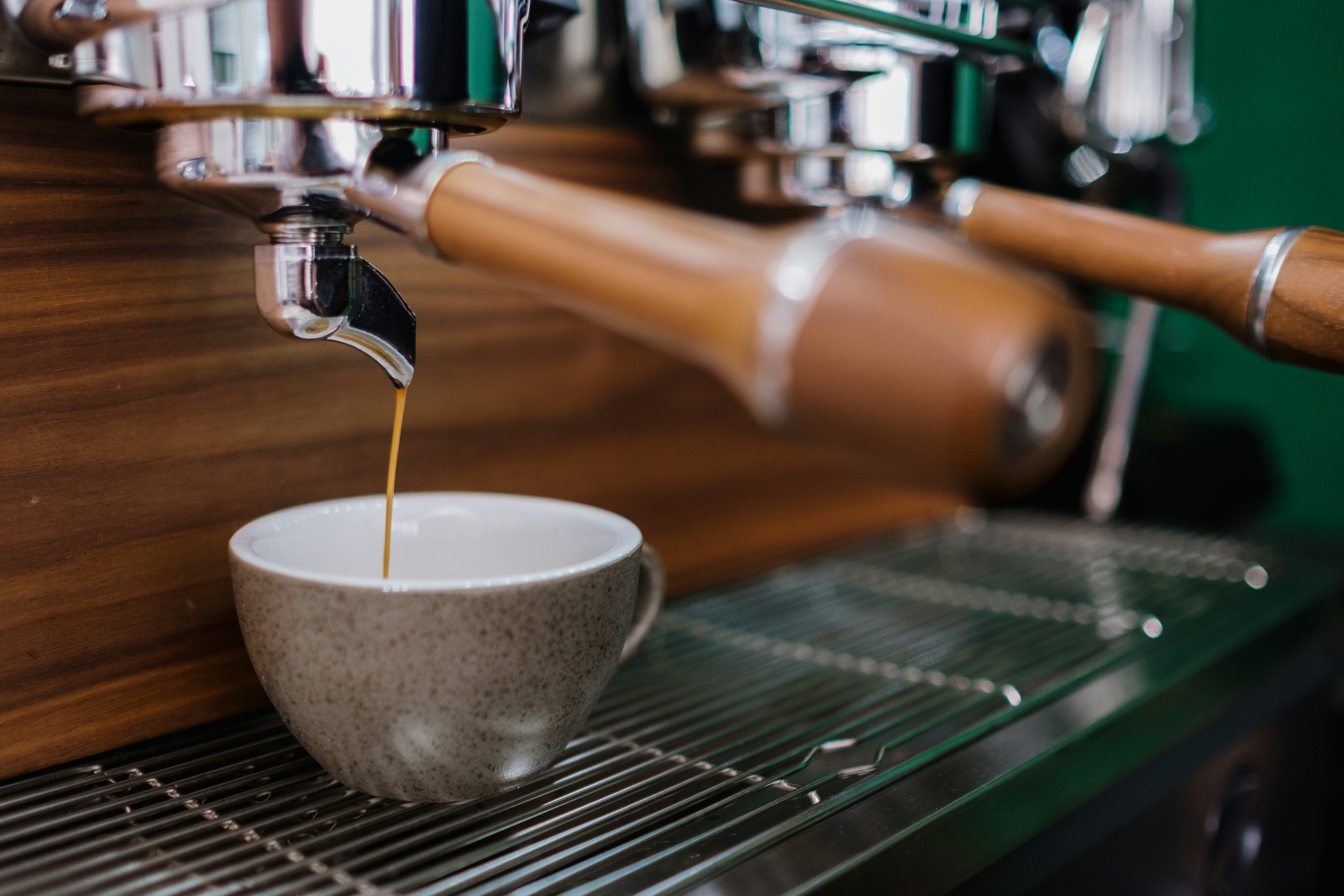 white ceramic cup on stainless steel espresso machine